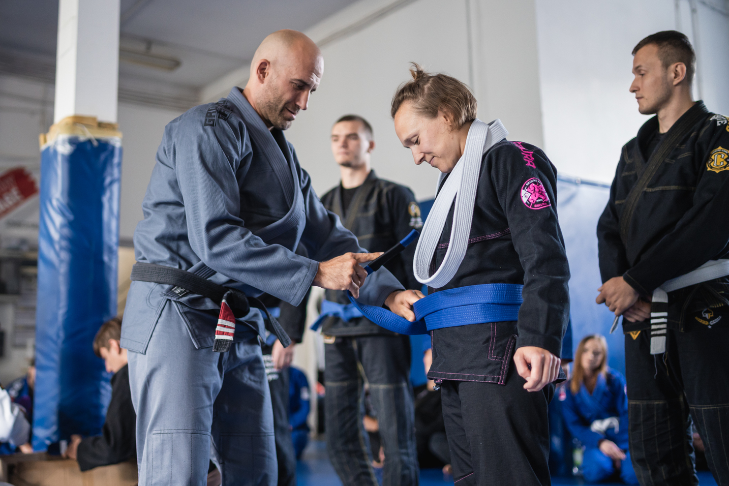 Woman promoted to blue belt by BJJ coach