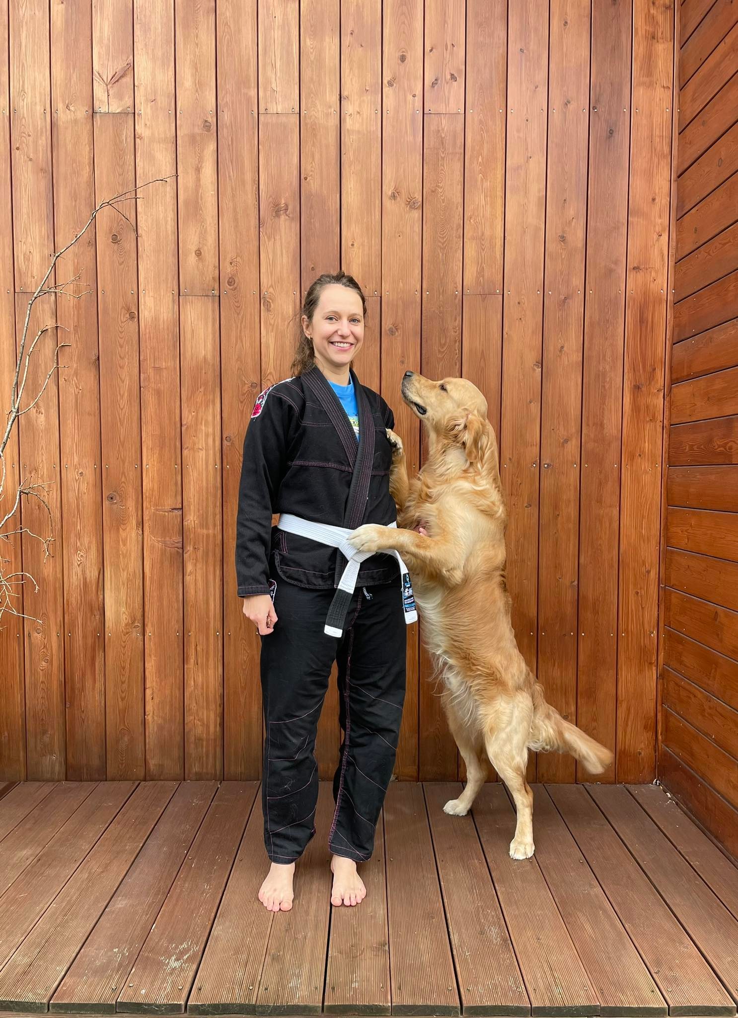 Woman in Brazillian Jiu Jitsu Gi with a dog