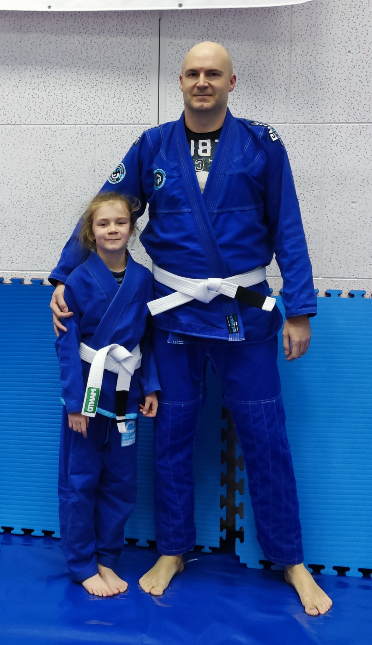 Jiu Jitsu practitioner holding his daughter